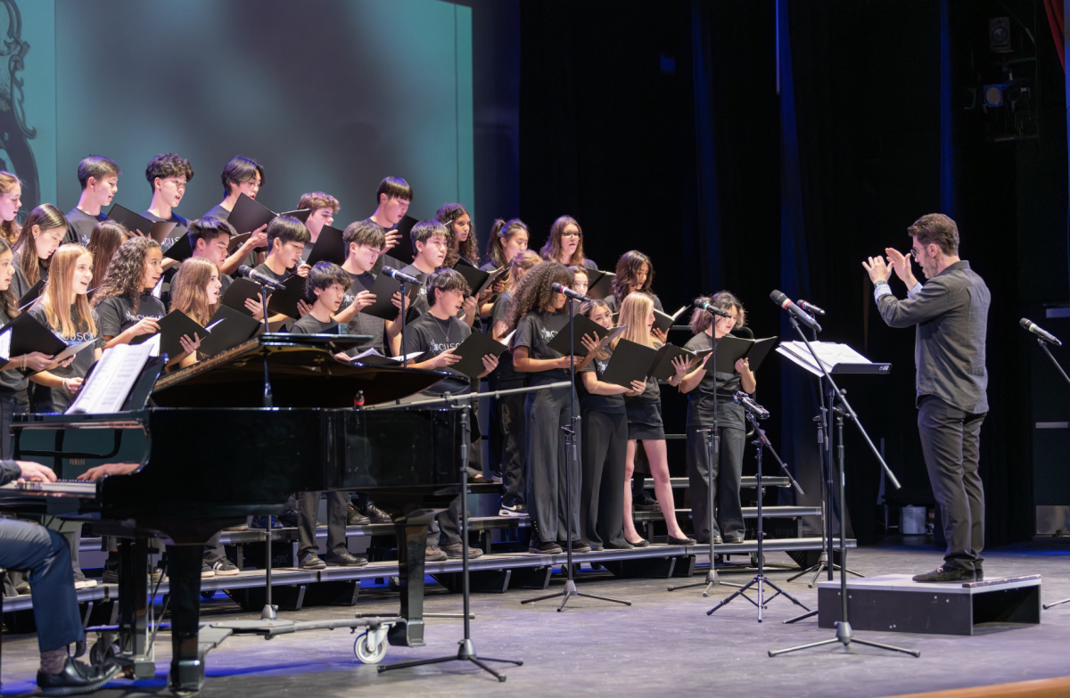 Vocal Music Teacher Scott Joiner leads the Upper School Chorus in one of the many great performances of the night.